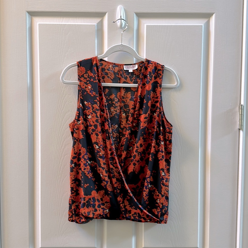 Orange/navy floral surplus sleeveless blouse. Vertical slits in back. Small,